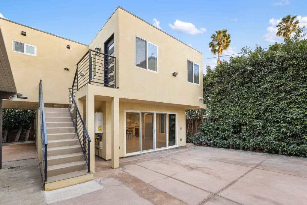 Modern two-story detached ADU with private stair access and sliding glass doors in West Los Angeles, built by MEDevelopment,Inc. – ADU Builders.