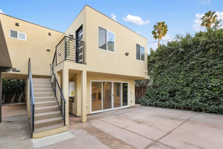 Modern two-story detached ADU with private stair access and sliding glass doors in West Los Angeles, built by MEDevelopment,Inc. – ADU Builders.
