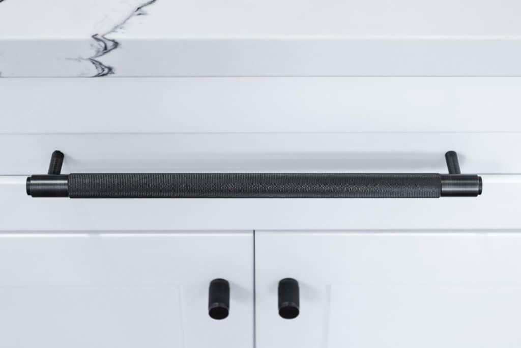 Modern black cabinet pull handle on white shaker kitchen drawer – Los Angeles ADU builder ADU Garage Conversion detail